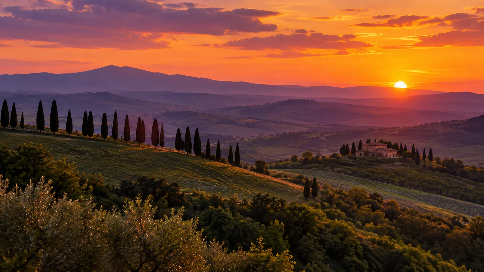Sunset over the Tuscan hills with cypress trees on a ridge